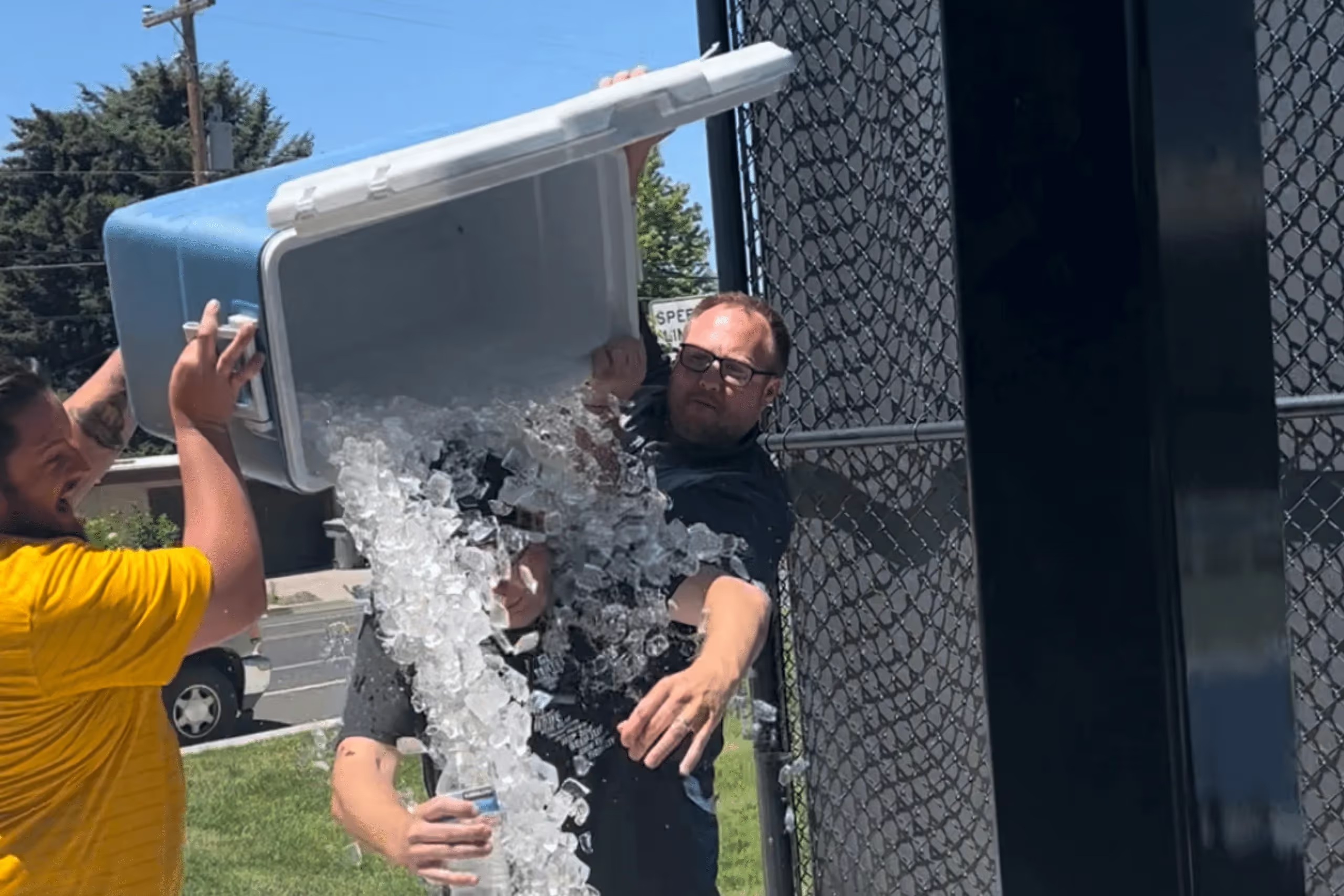 Shaun Sorensen receives a cooler of ice water after winning Kenect’s company pickleball tournament