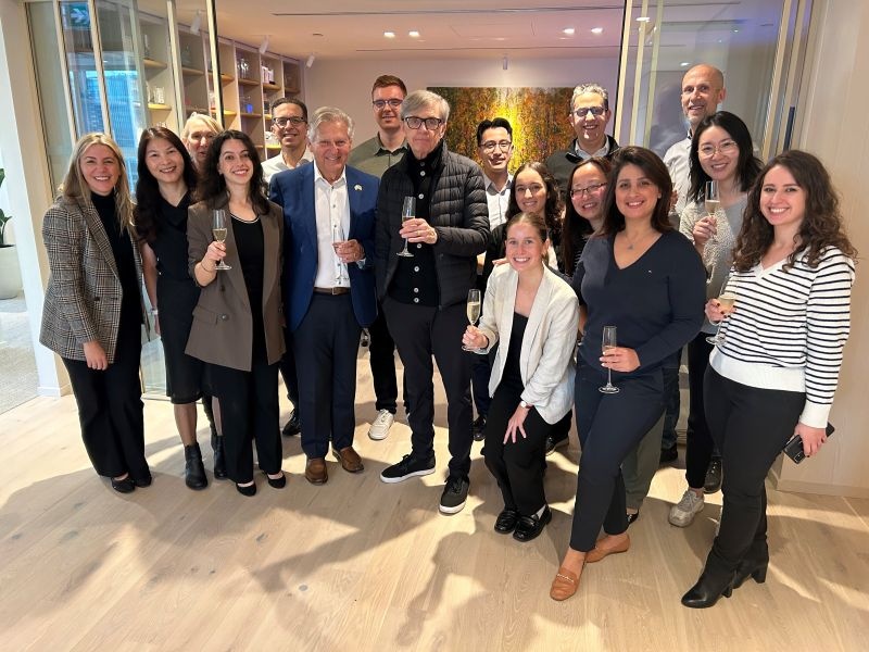 Tricor colleagues raising glasses at the Johnstone Room celebration in Vancouver