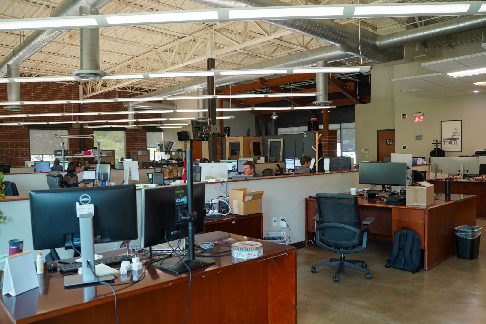 Rows of desks, computer monitors and workstations in Emporia’s open workspace