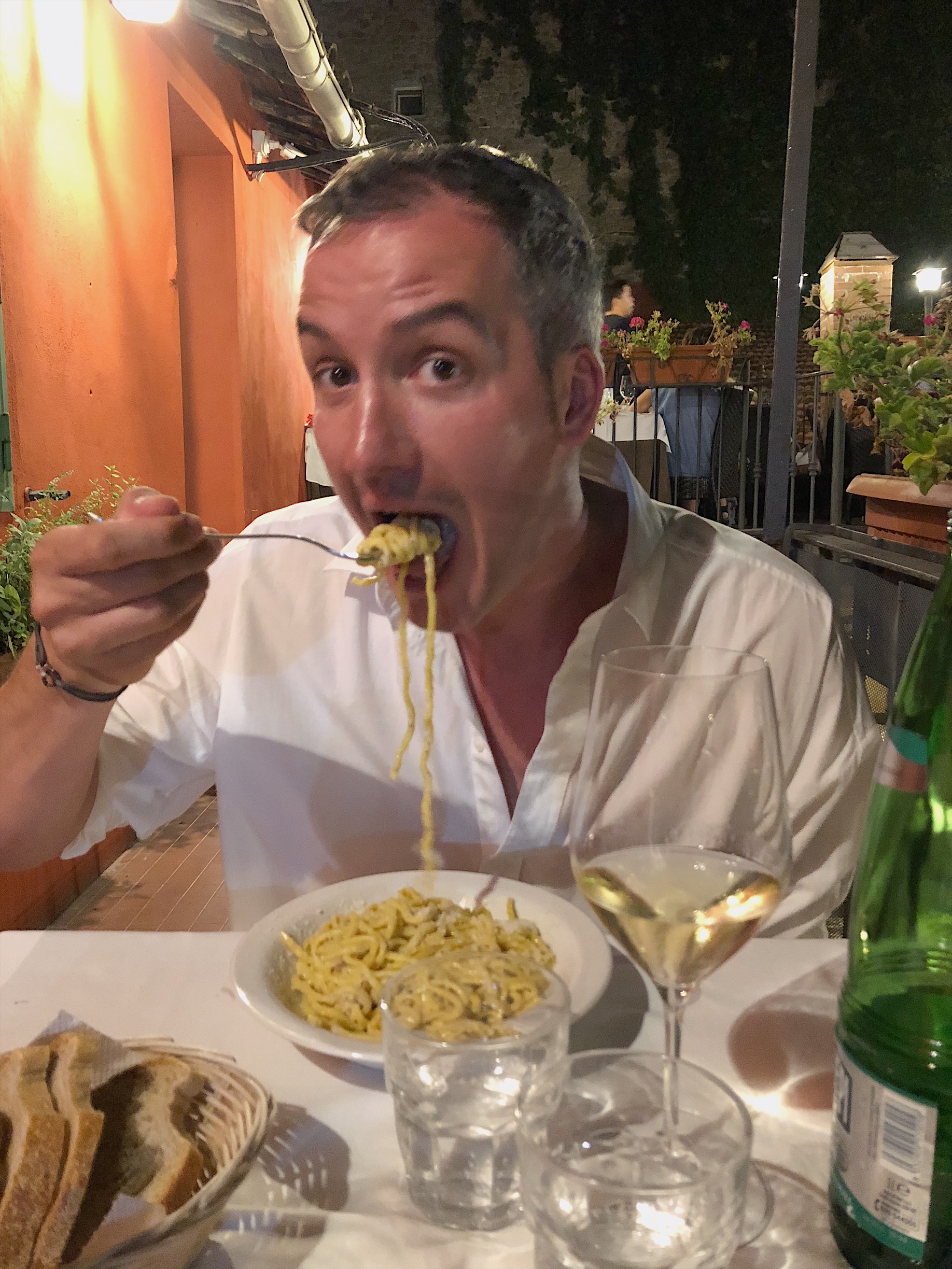 Shawn Rusich eating cacio e pepe at a restaurant in Rome.