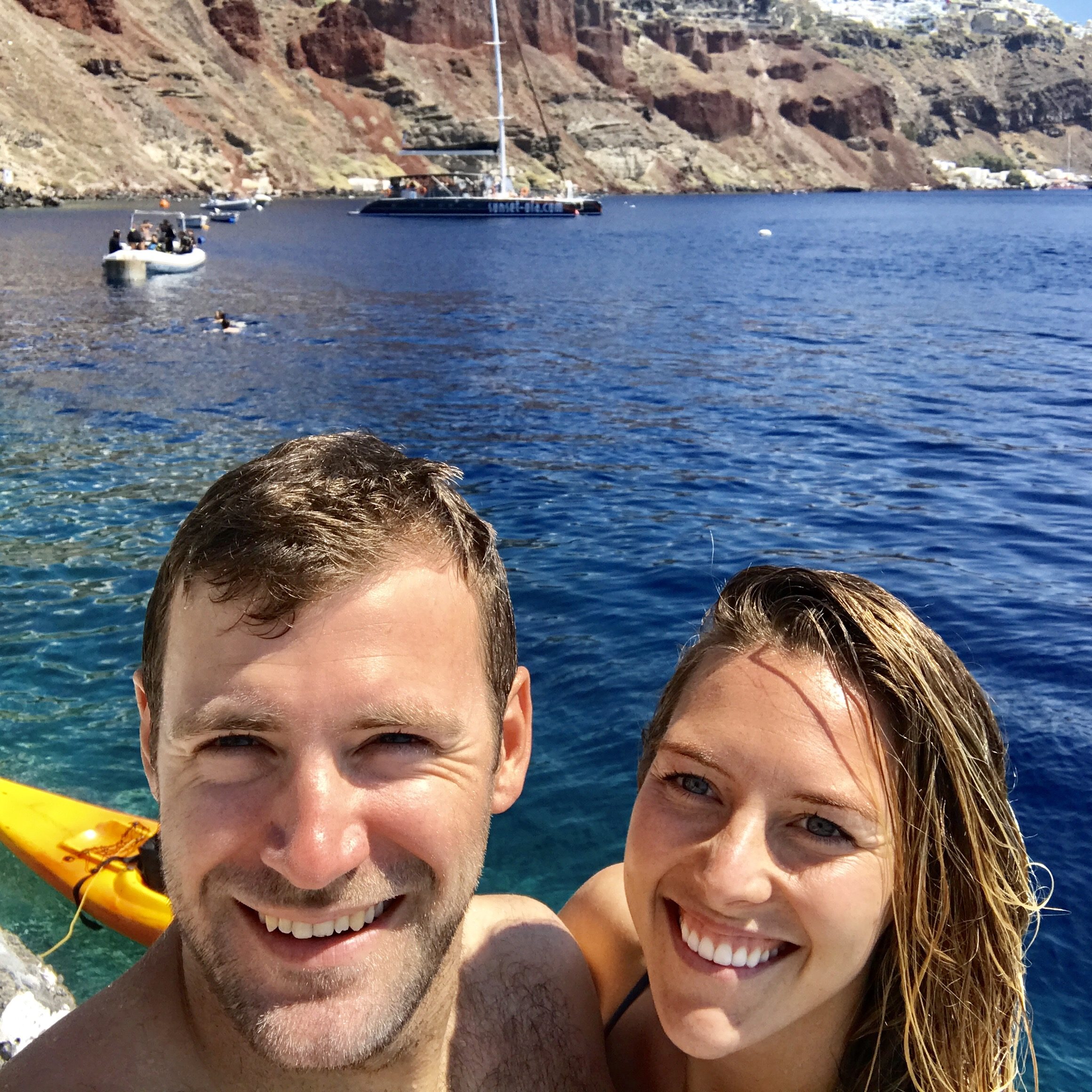 Shawn Szurley smiling beside a companion on bright blue water