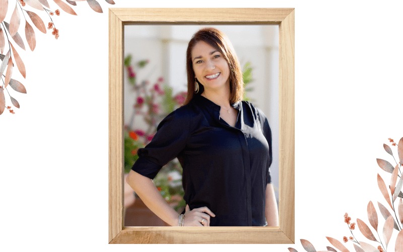 Shawna Kremer in a sunlit portrait framed by botanical artwork