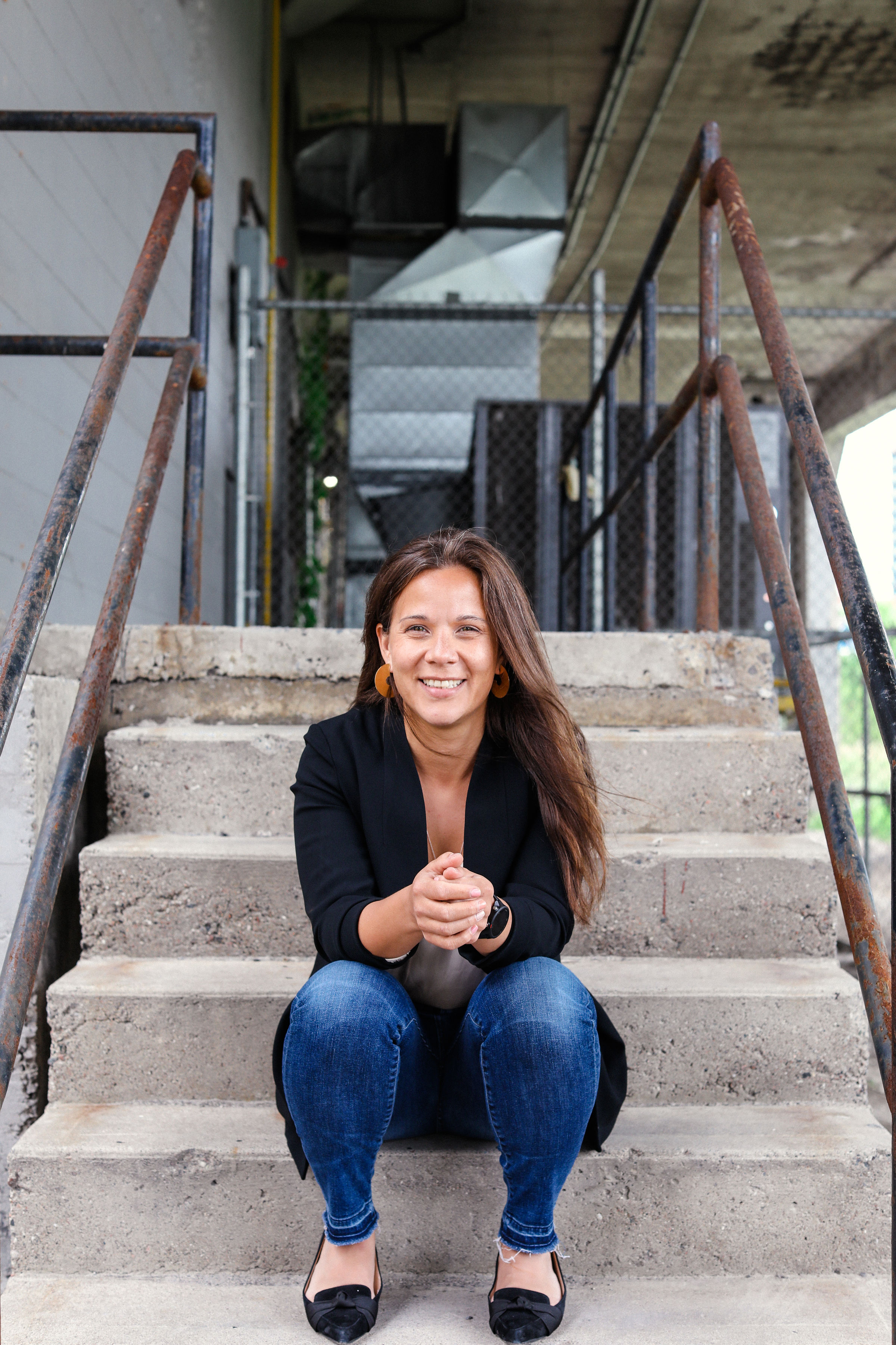 Shawna Newbery seated on concrete stadium steps