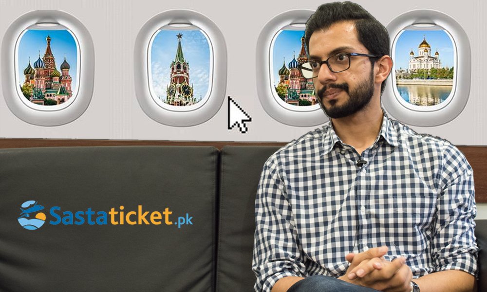 Shazil Mehkri seated for an interview in front of Sastaticket branding and illustrated aircraft windows