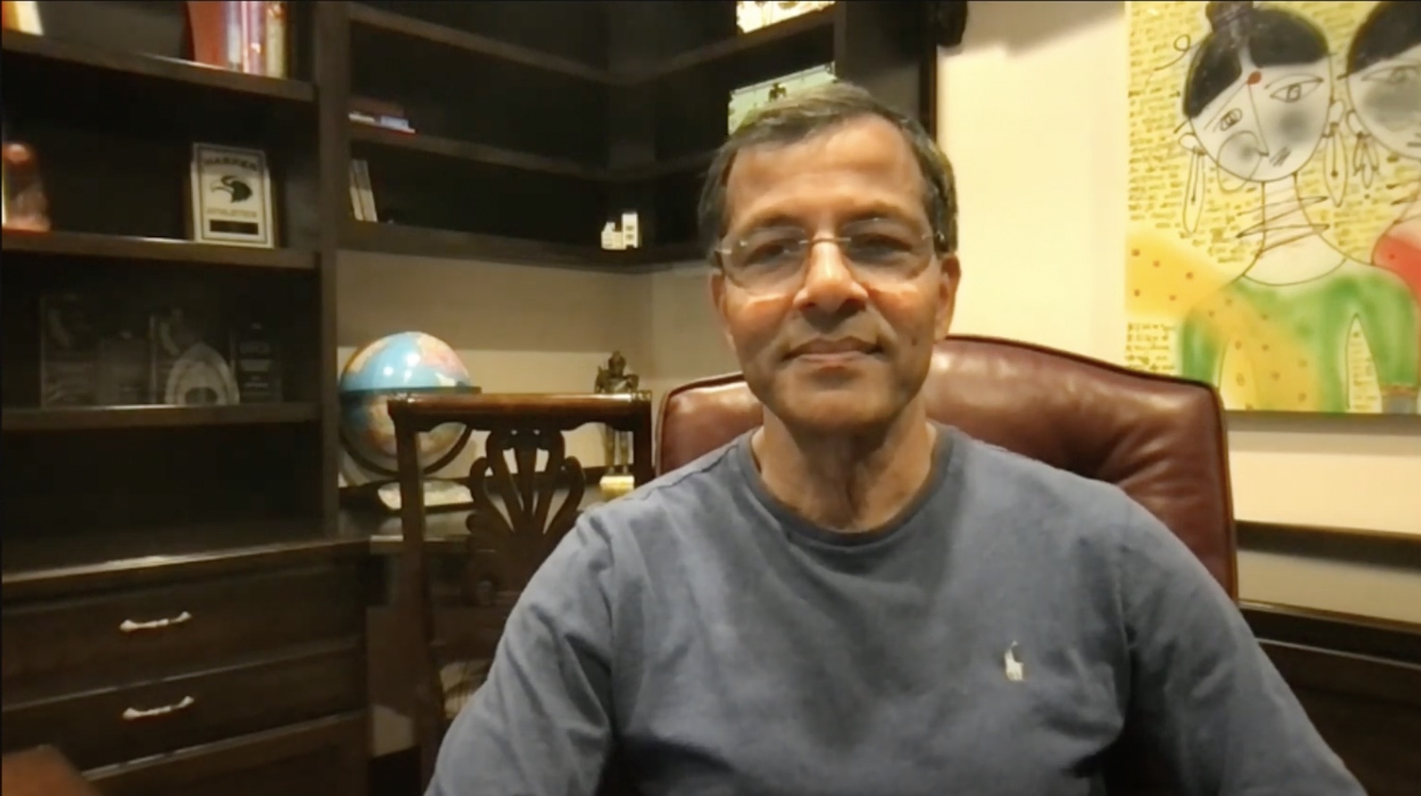 Shekar Ayyar seated in a book-lined office during a podcast conversation