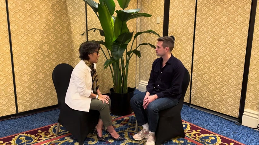 Sheri Chin speaking with an interviewer at Money20/20