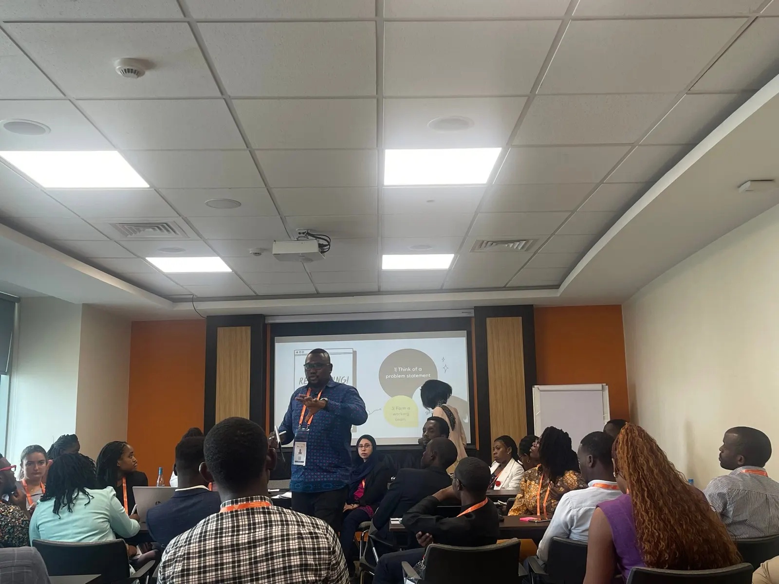 Sherif Ghali standing and speaking among seated workshop participants
