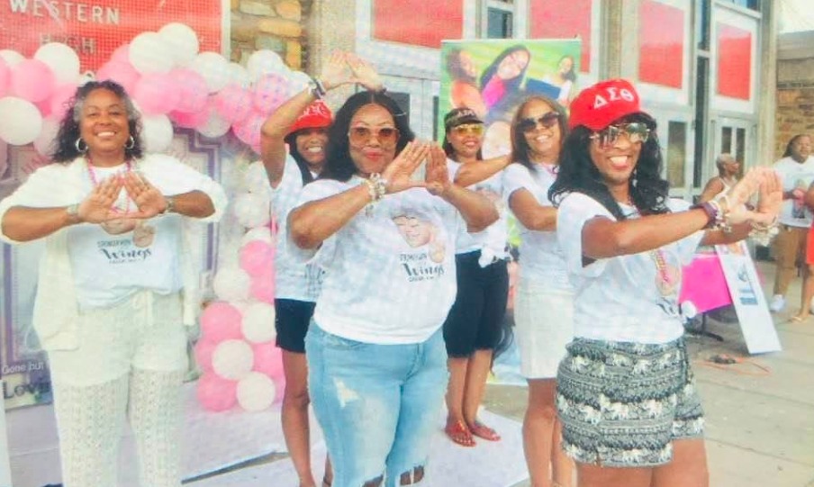 Members and supporters of the Charlize Angel LaTonya Gilliam Scholarship Foundation gather at a community event