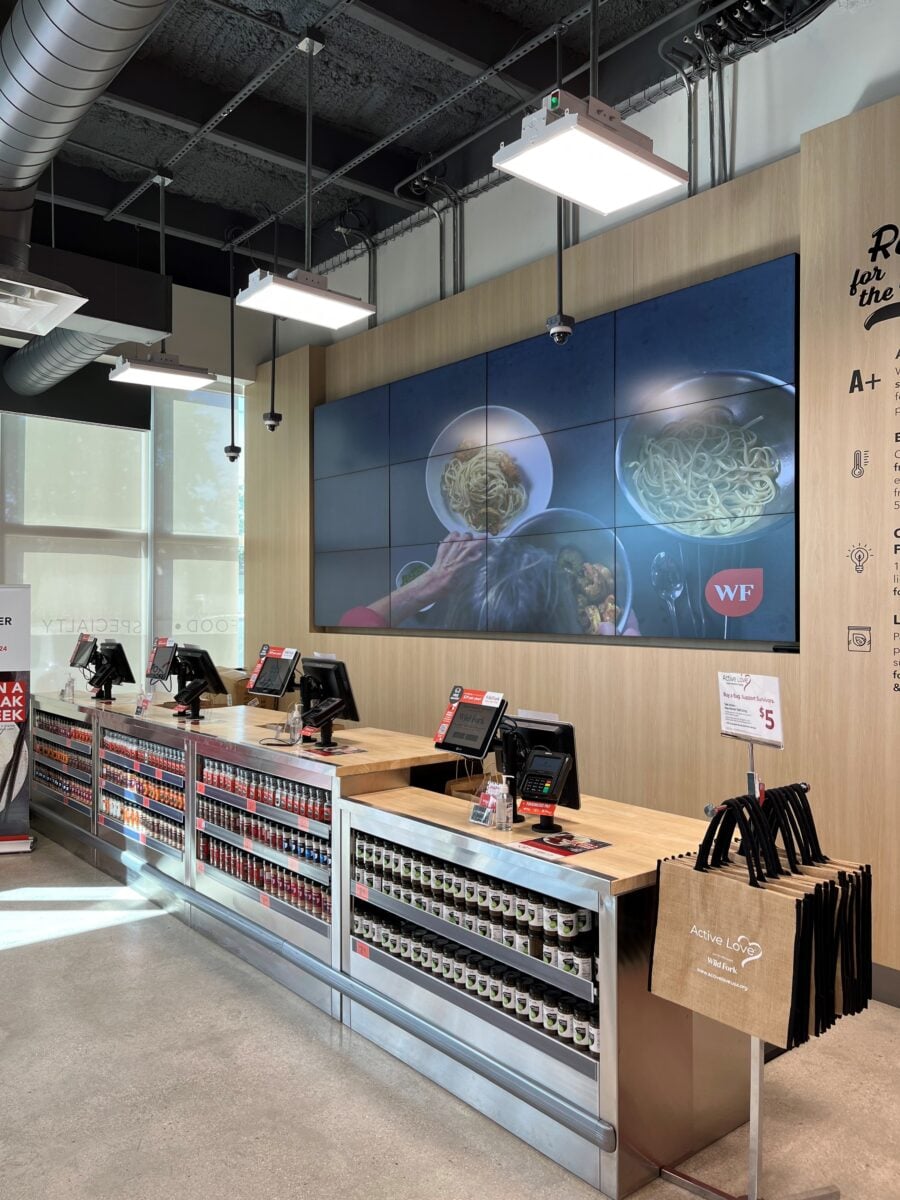 The checkout area at Wild Fork's Canadian store, with wood counters and a large food display