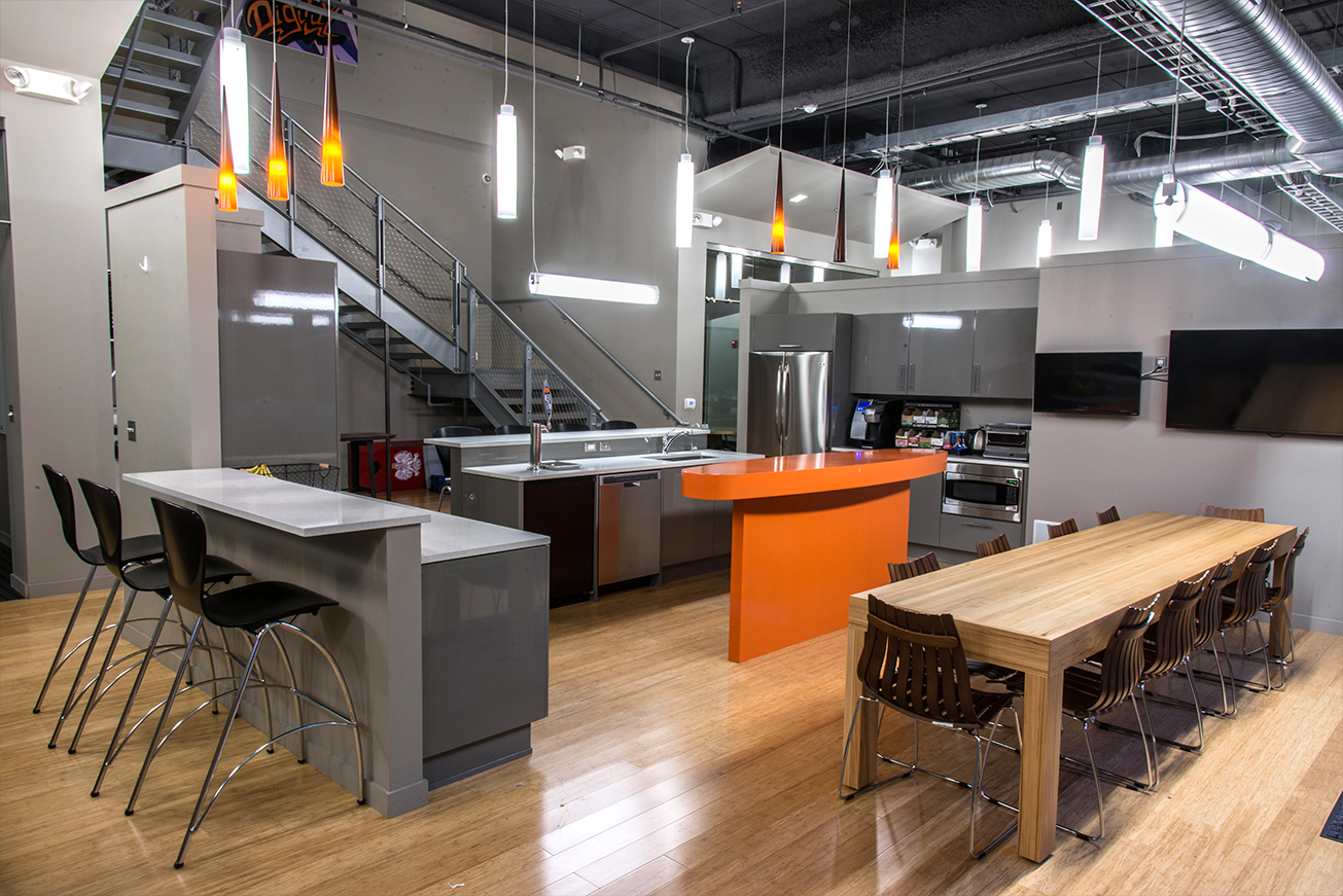 Shared kitchen and communal tables inside a Shift Digital workspace