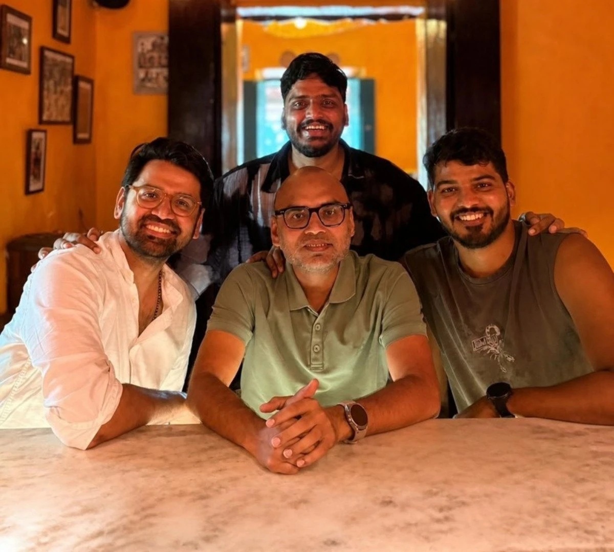 The four Shifu Ventures partners gathered around a table