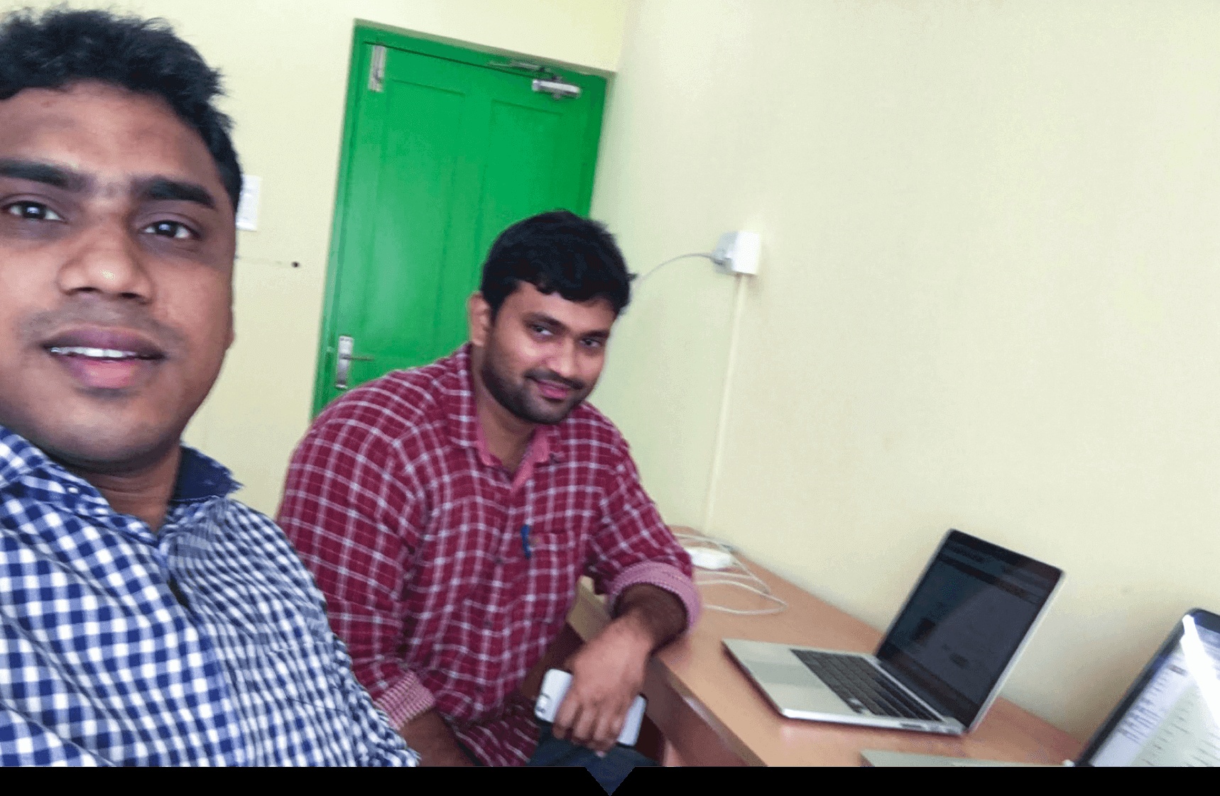 Shihab Muhammed and Subin Sebastian with laptops in SurveySparrow's first small office in Kochi