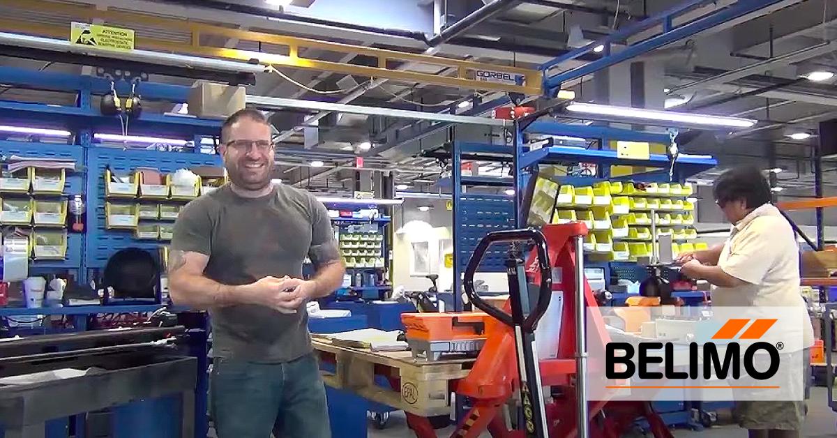 A Belimo employee beside packing equipment and warehouse workstations