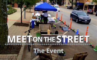 A temporary street demonstration with blue canopy, cones and planters on Armour Road