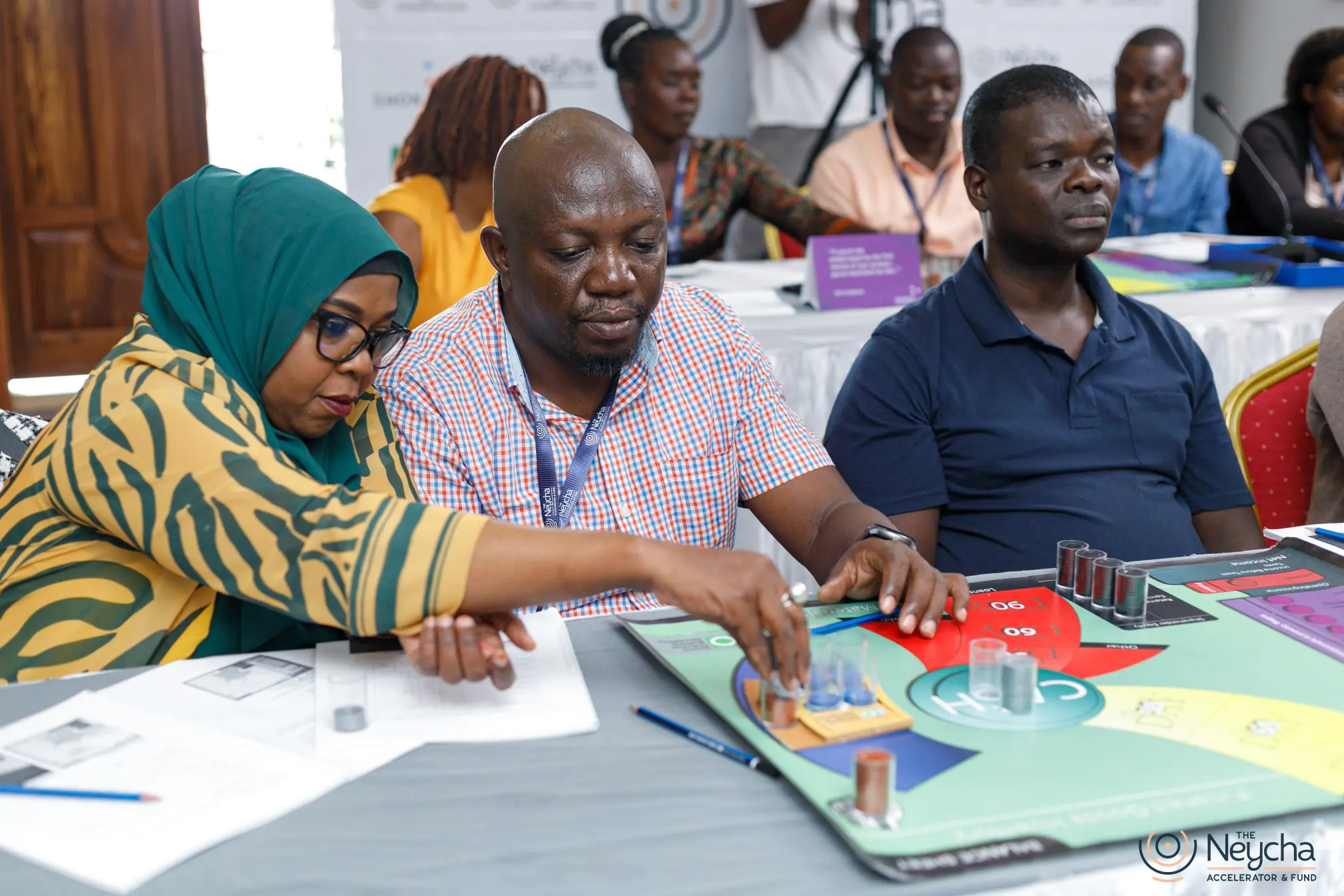 Neycha entrepreneurs use a tabletop financial simulation during a workshop