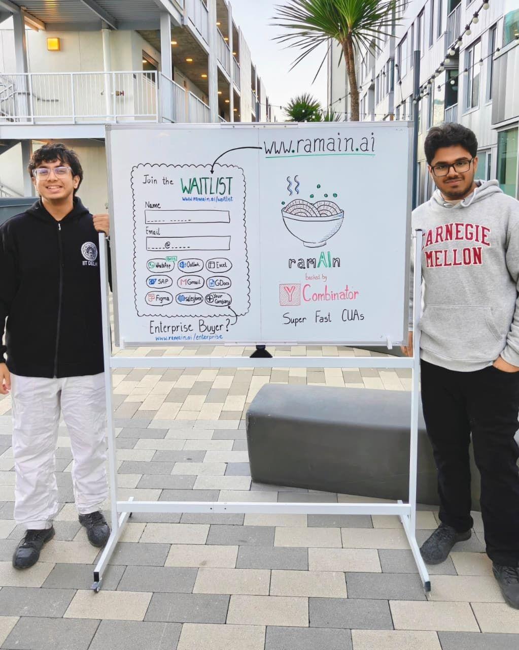 Shourya Vir Jain, left, and Vansh Ramani beside RamAIn’s hand-drawn launch whiteboard