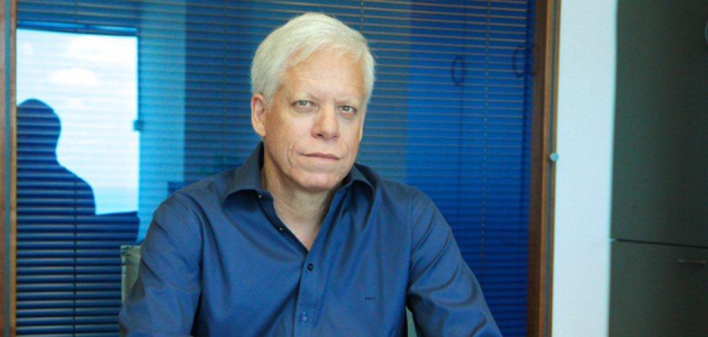 Shraga Katz seated in an office, wearing a blue shirt