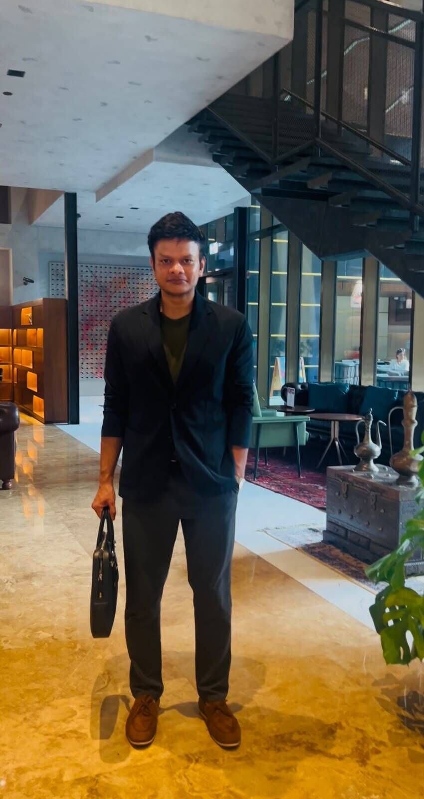 Shubham Garg standing with a briefcase in a photograph shared with his July 2026 Dubai expansion announcement