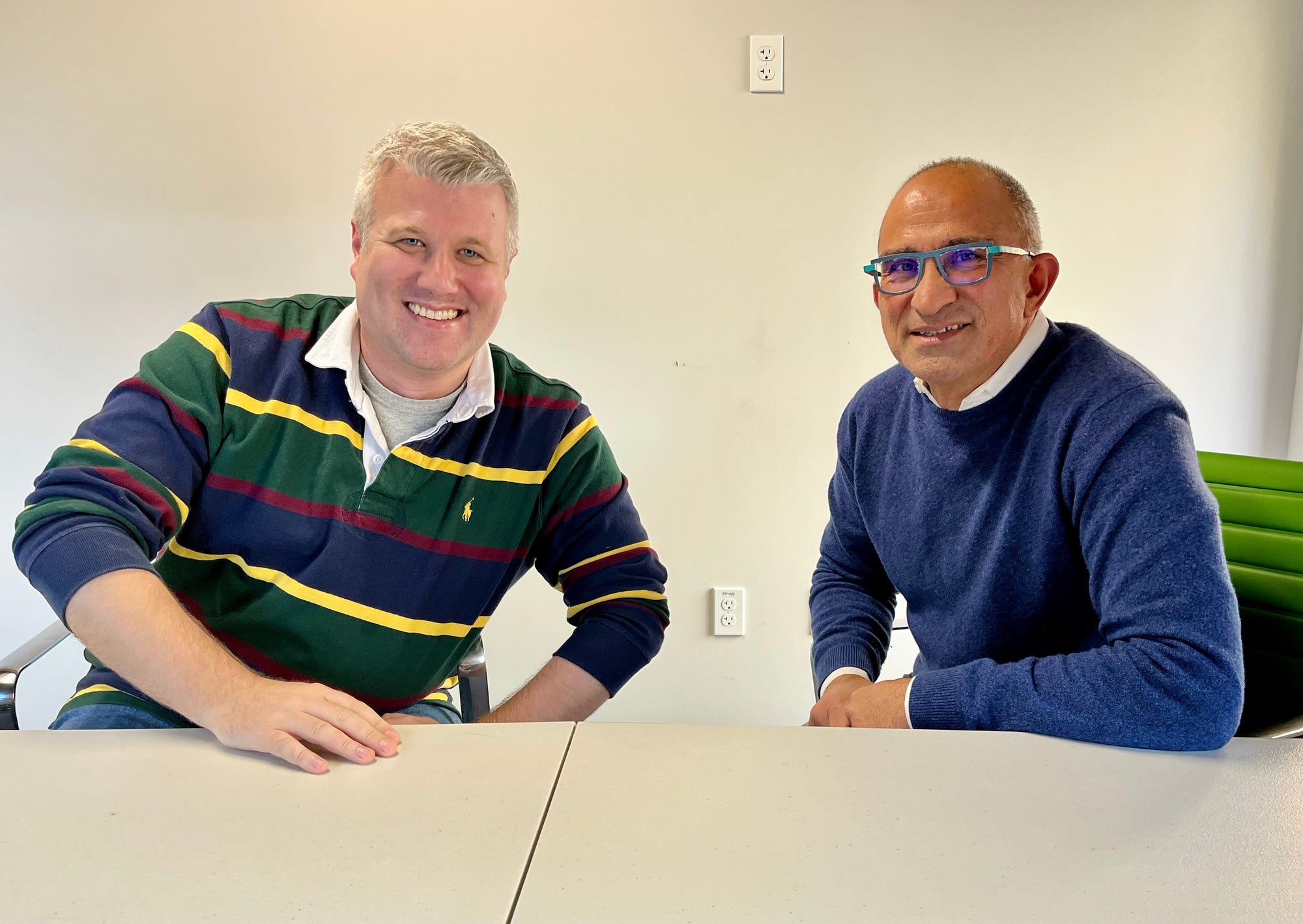 Labviva co-founders Nicholas Rioux, left, and Siamak Baharloo, right, seated at a conference table