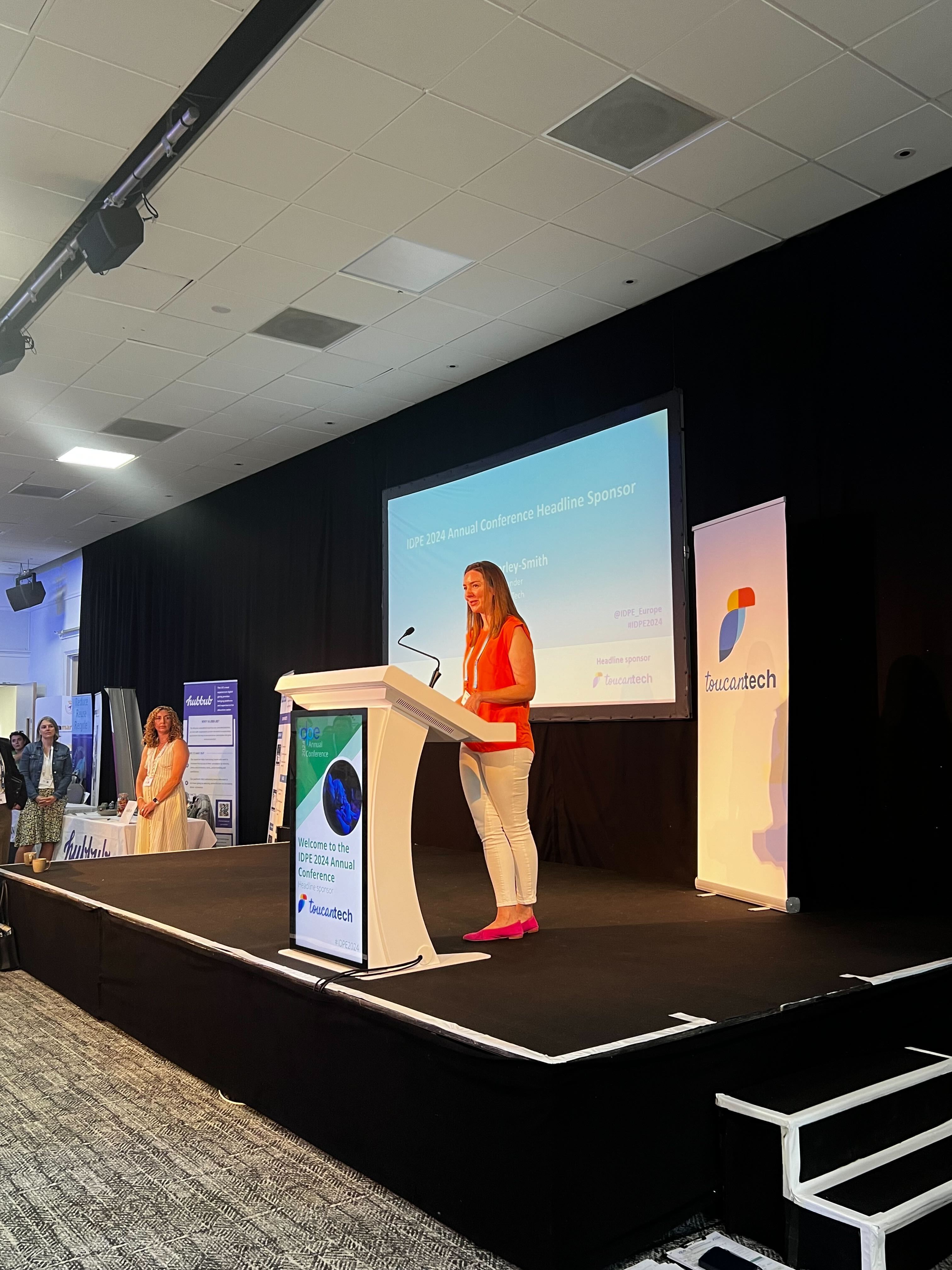Sian Morley-Smith speaking at a lectern at the IDPE 2024 Annual Conference