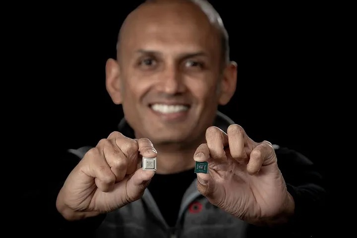 Sid Sheth holds two d-Matrix development chips against a dark background