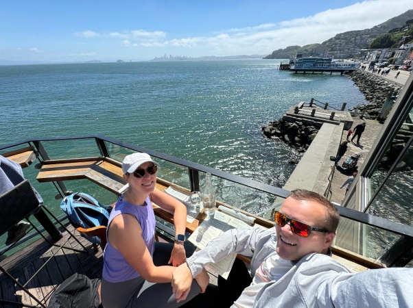 Sid Sijbrandij and Karen smiling together beside the water