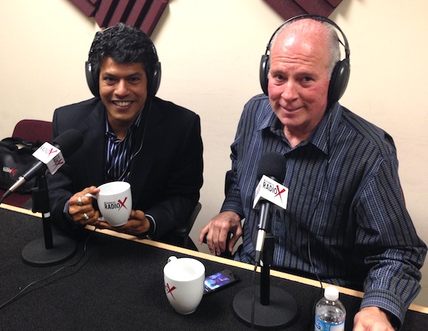 Sidd Ahmed, left, and Jim Berryhill wearing headphones beside radio microphones