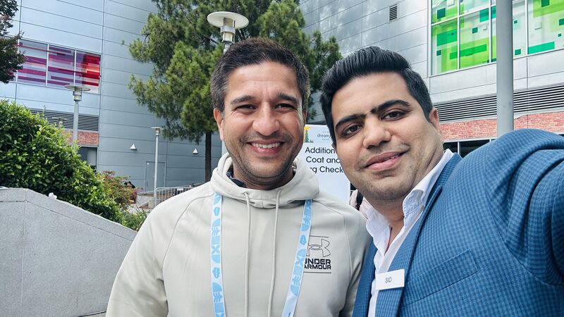Siddharth Sehgal, right, taking a selfie with a fellow attendee outside the Dreamforce 2024 venue