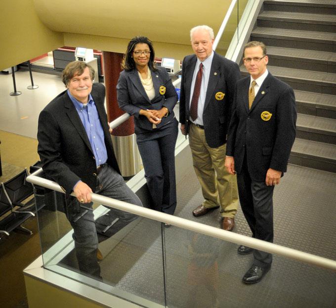 Larry Sides with Lafayette airport commissioners inside the terminal