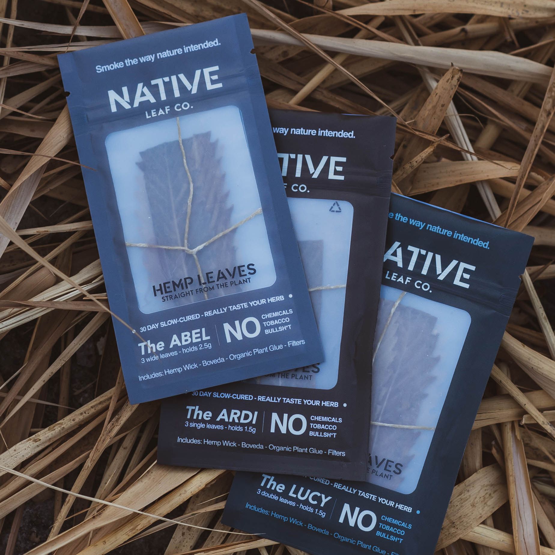 Native Leaf Co. ABEL, ARDI and LUCY hemp leaf wrap packages arranged on dried leaves