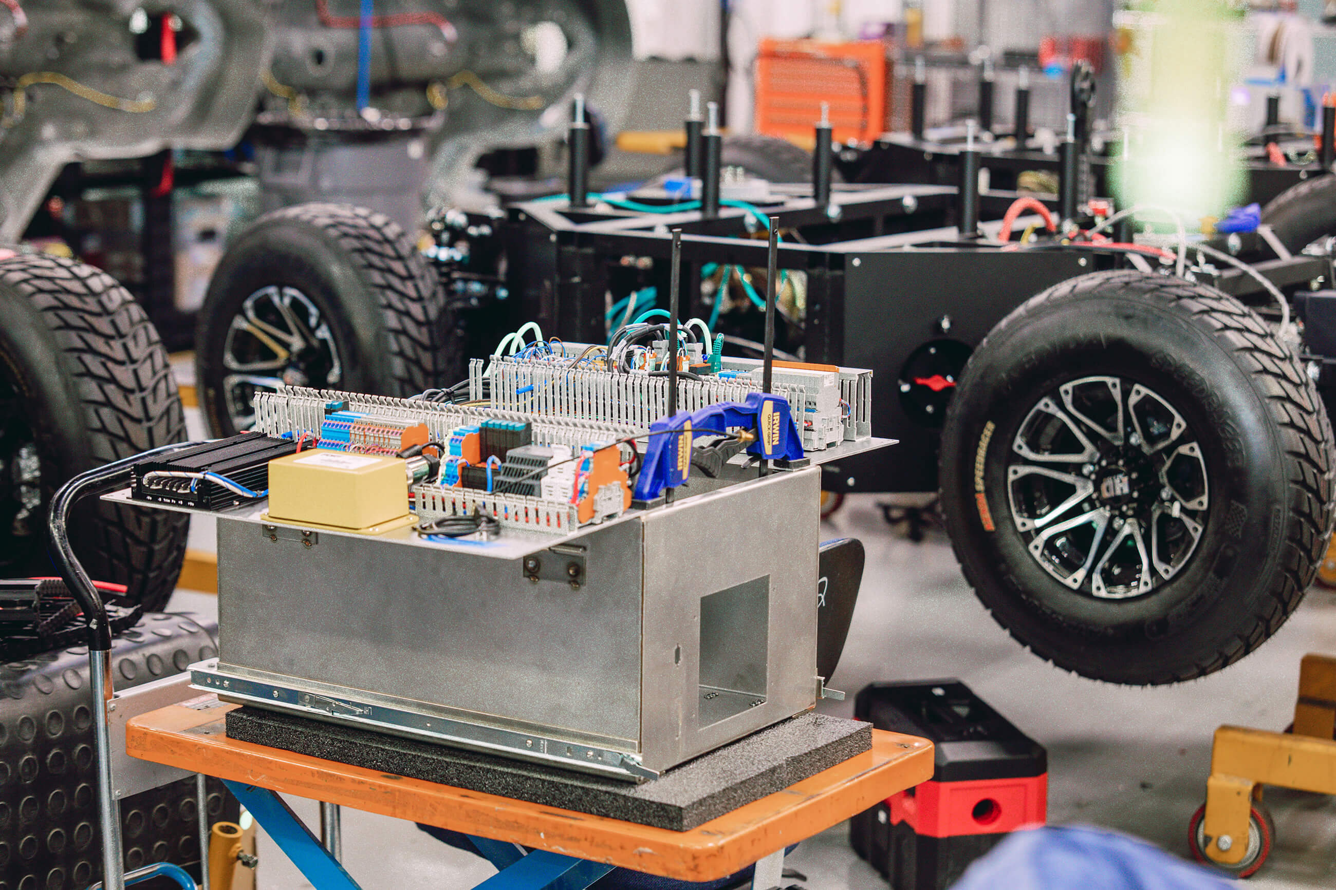 Autonomous ground vehicle chassis and electrical assembly in Sigma Design’s workshop