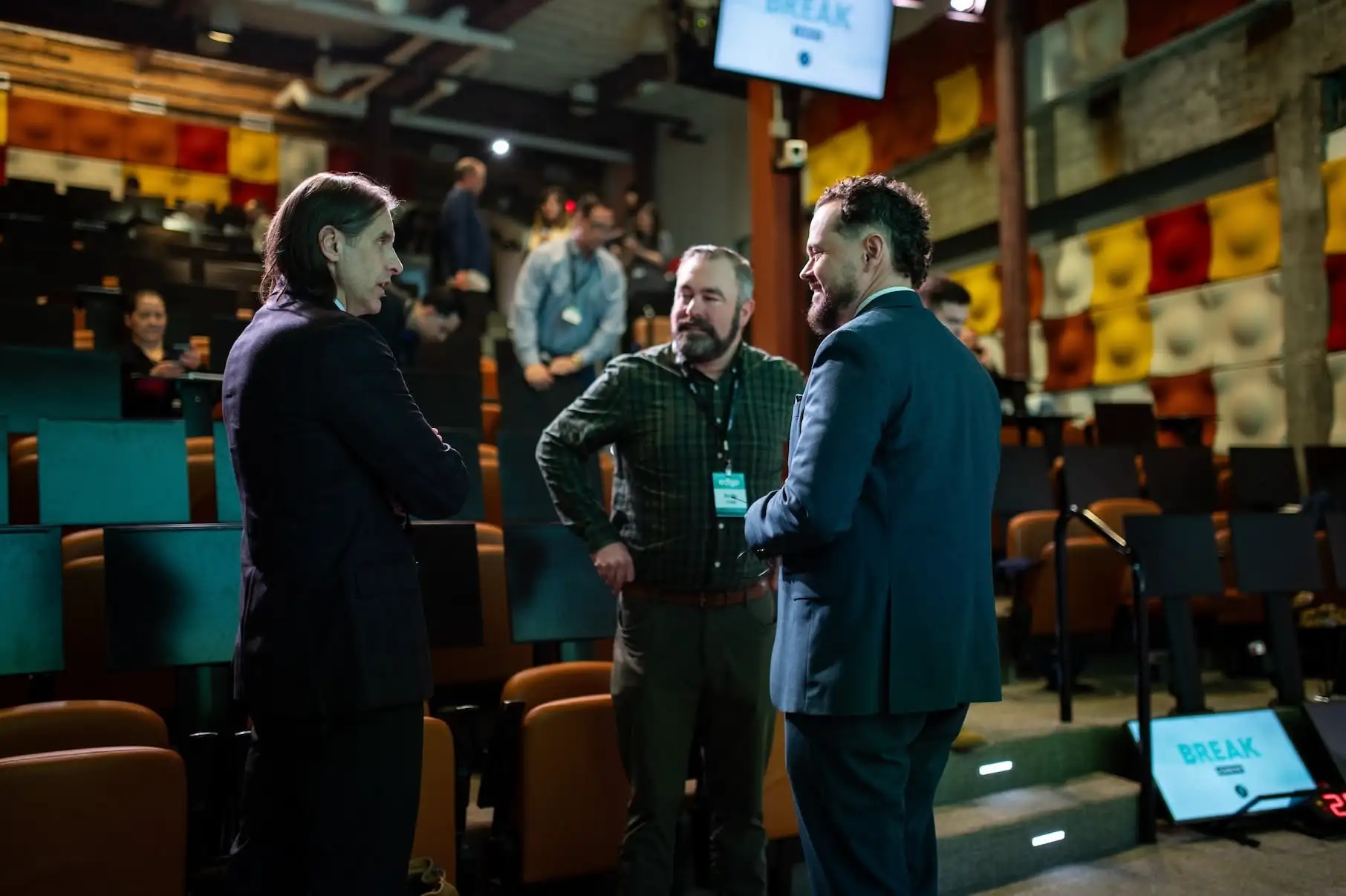 Attendees talking at an advisor gathering shown on Signal’s website