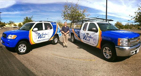 Two Window World vehicles with coordinated blue, white and yellow graphics