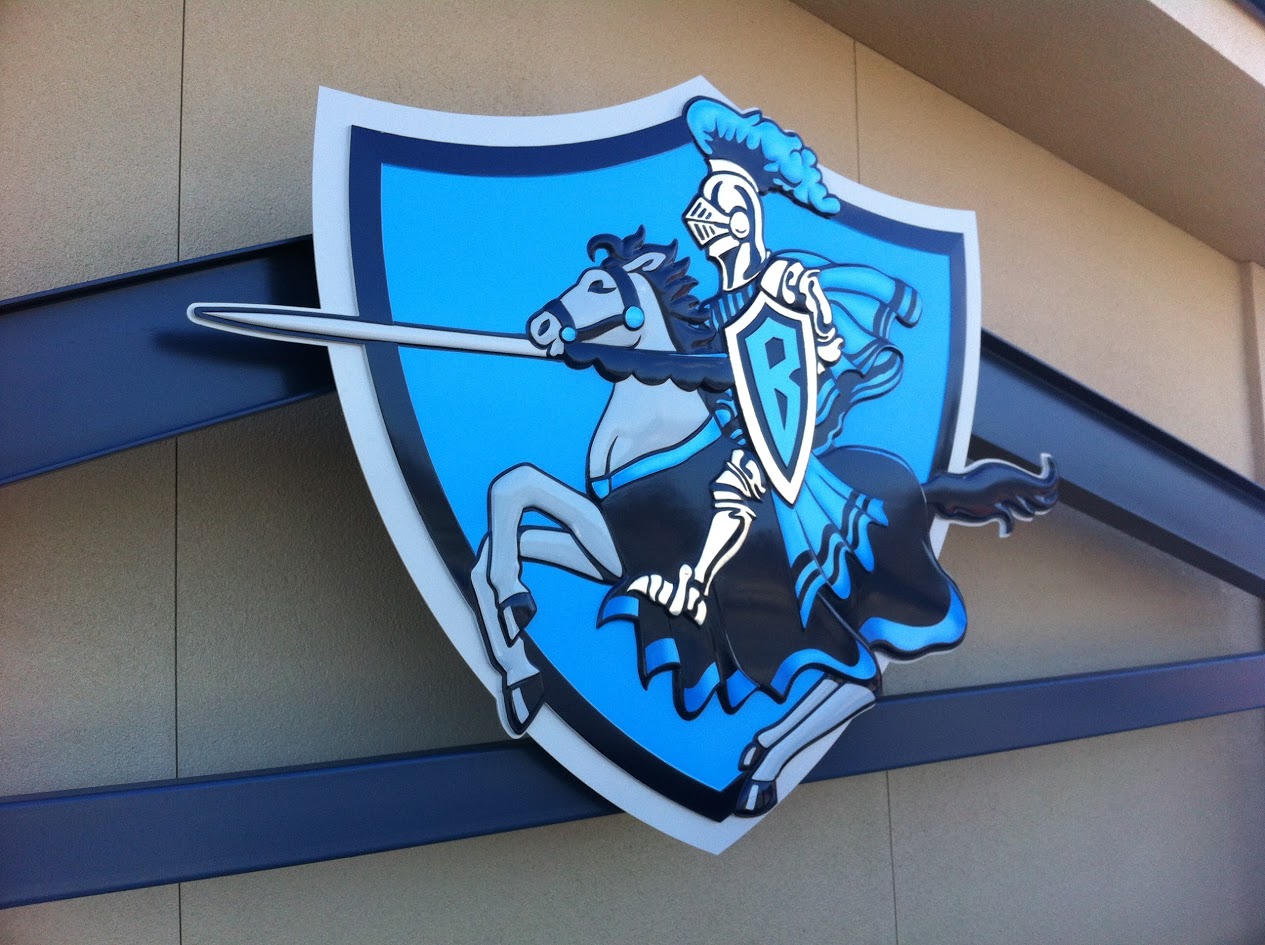 Blue and white dimensional sign showing a knight on horseback with a lance extending past a shield