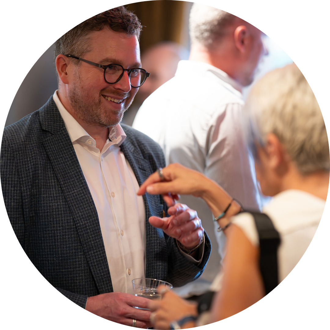 People talking at a Silverchair gathering, shown in the company’s leadership-page imagery