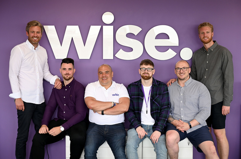 Simon Hills, standing at the far left, with five members of Wise’s senior management team