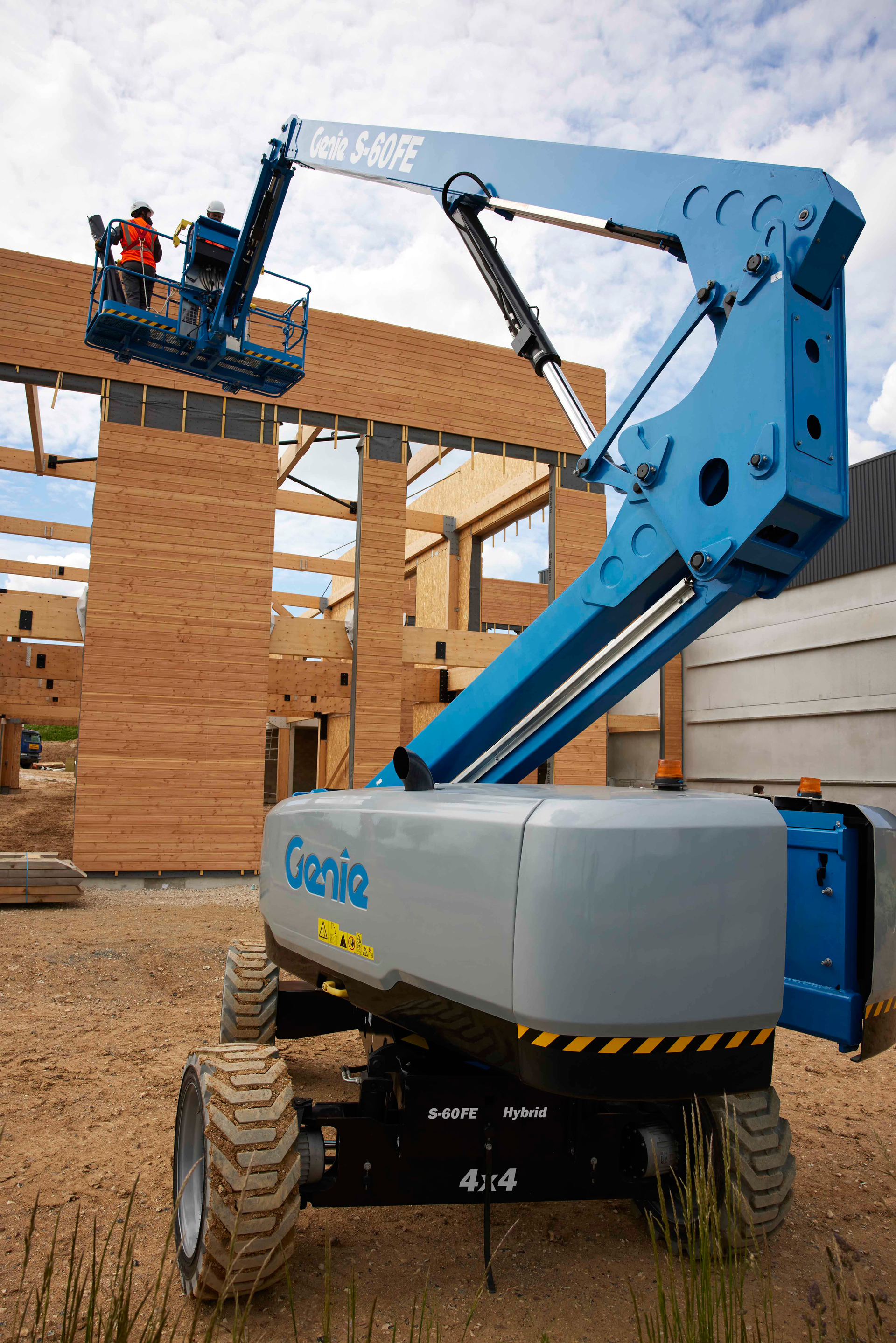 A blue Genie S-60 FE boom lift at a steel erection jobsite