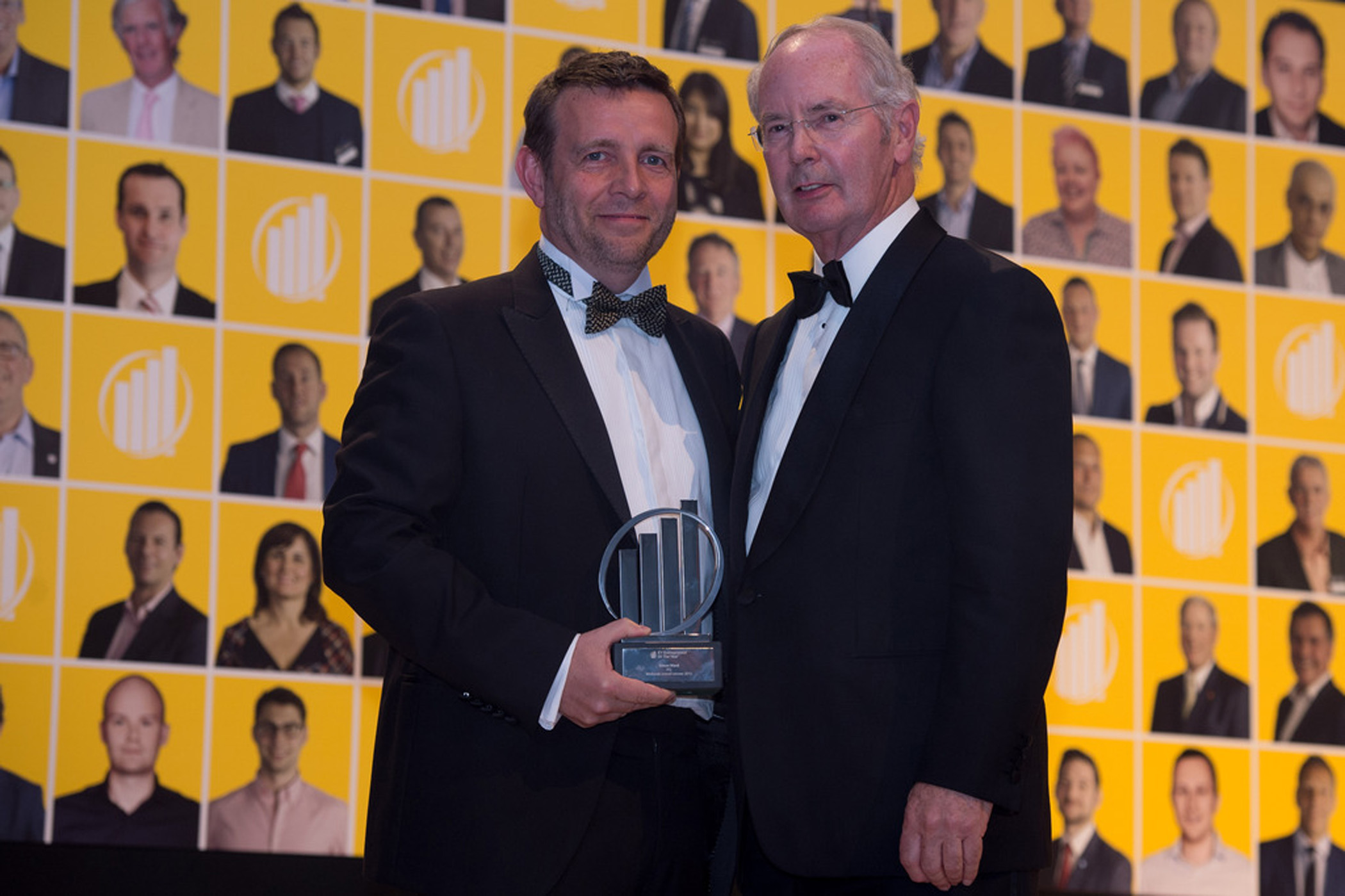 Simon Ward, left, receiving an EY award from Sir Peter Rigby in 2015