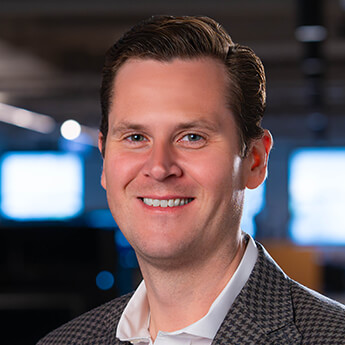 Simplex Trading CEO Erik Swanson, photographed with trading monitors behind him