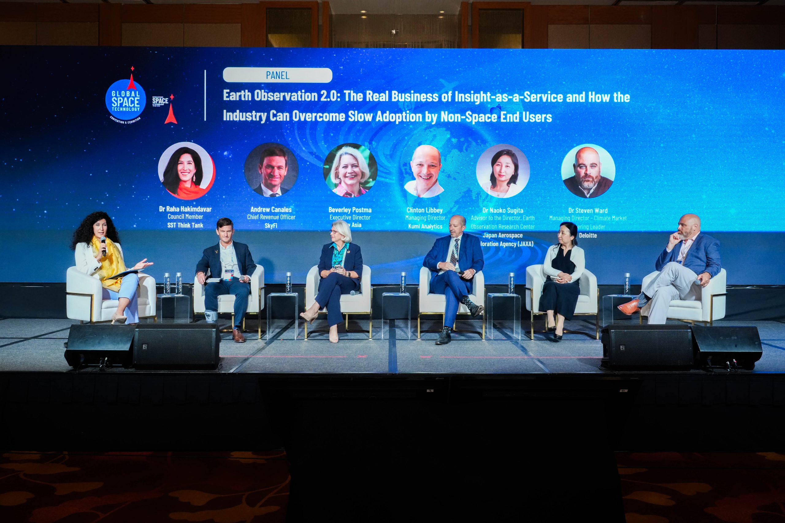Six speakers on the GSTCE 2026 stage discussing Earth observation and slow adoption by non-space customers