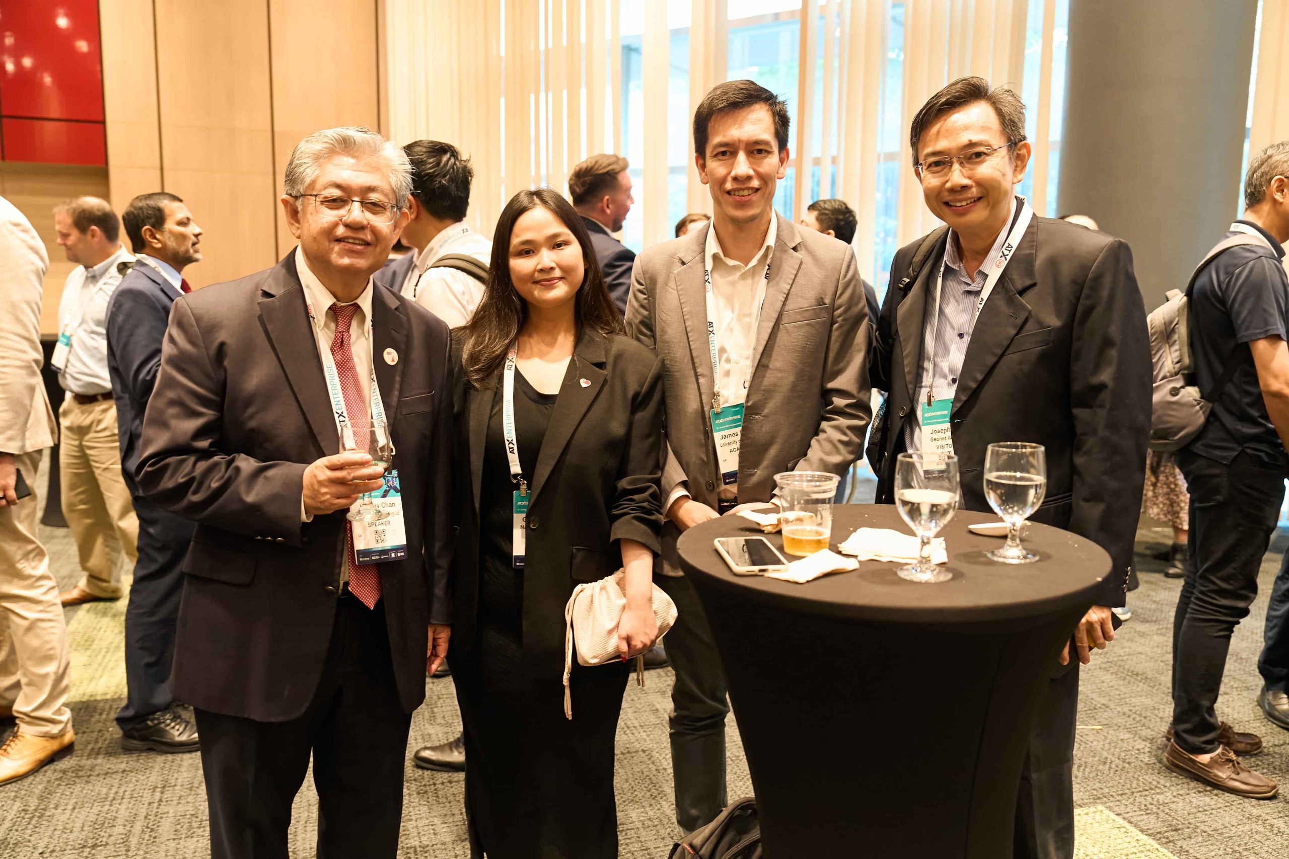 Attendees talking around a standing table at an SSTTT industry event