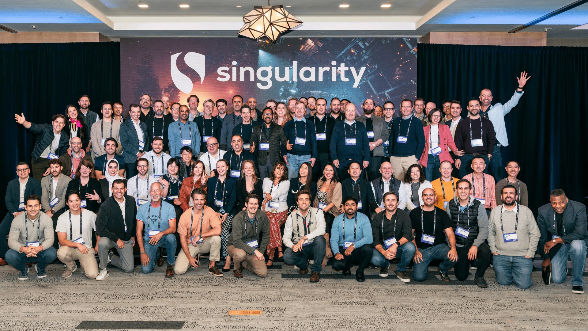 A group of Singularity program participants posing at an event