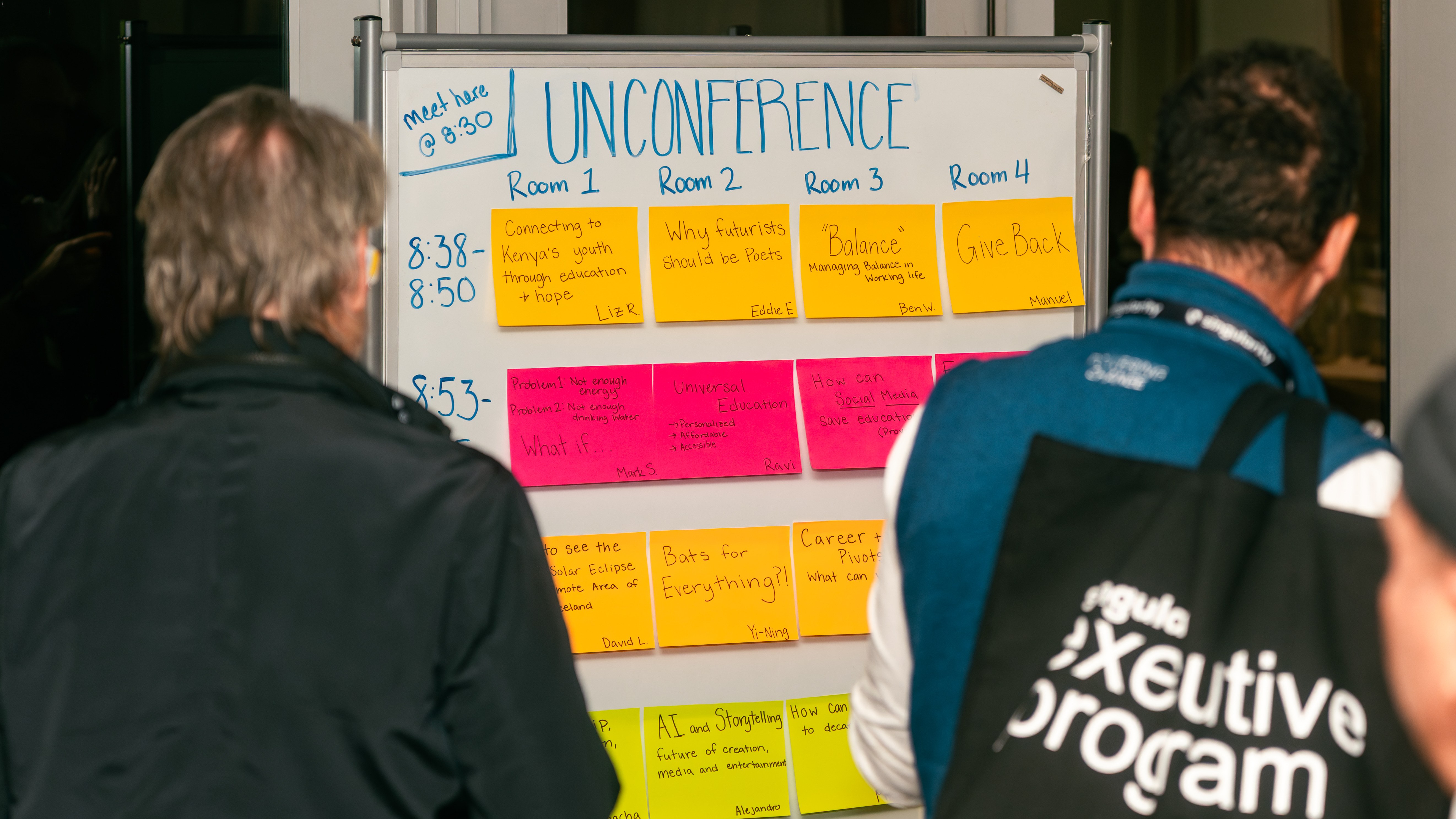 Participants working at a whiteboard during a Singularity executive program