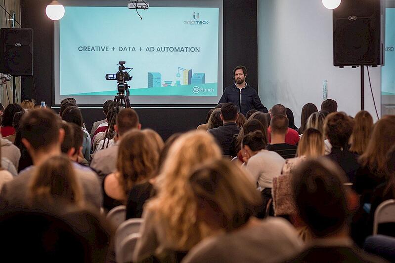 Sinisa Rakovic speaking to a seated audience at the MarTech Challenge, with a slide reading Creative + Data + Ad Automation