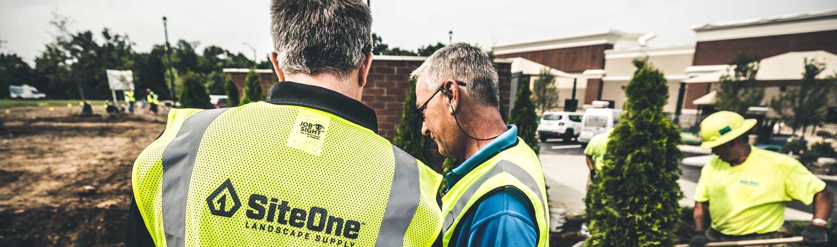 SiteOne project staff reviewing details beside a landscape installation