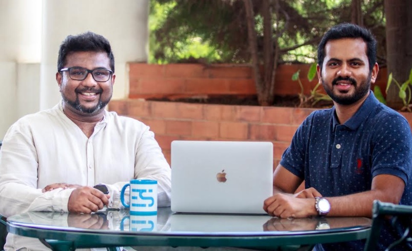 Everstage co-founders Vivek Suriyamoorthy, left, and Siva Rajamani, right, seated at a table with a laptop.