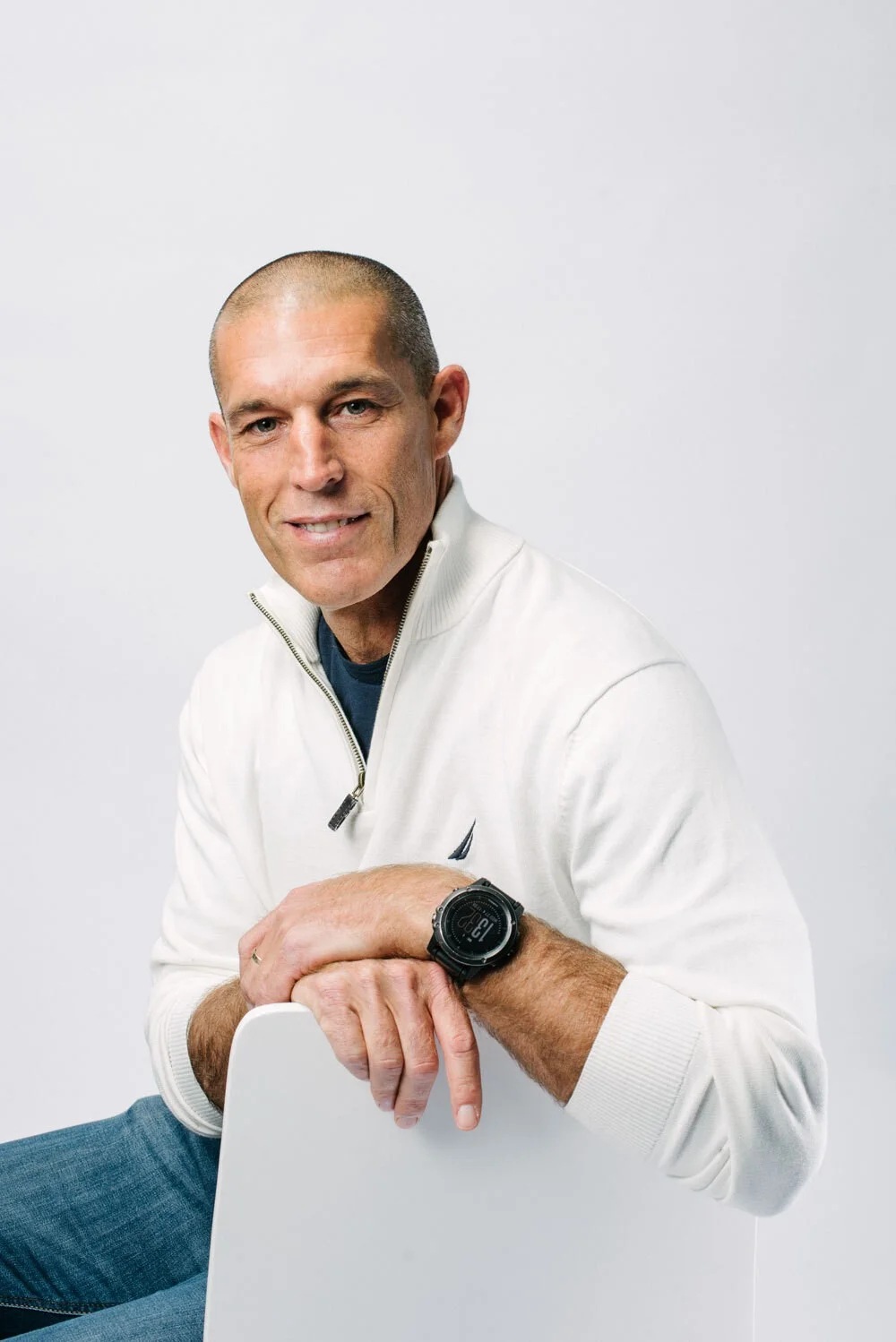 Skai co-founder and CEO Yoav Izhar-Prato seated on a white chair