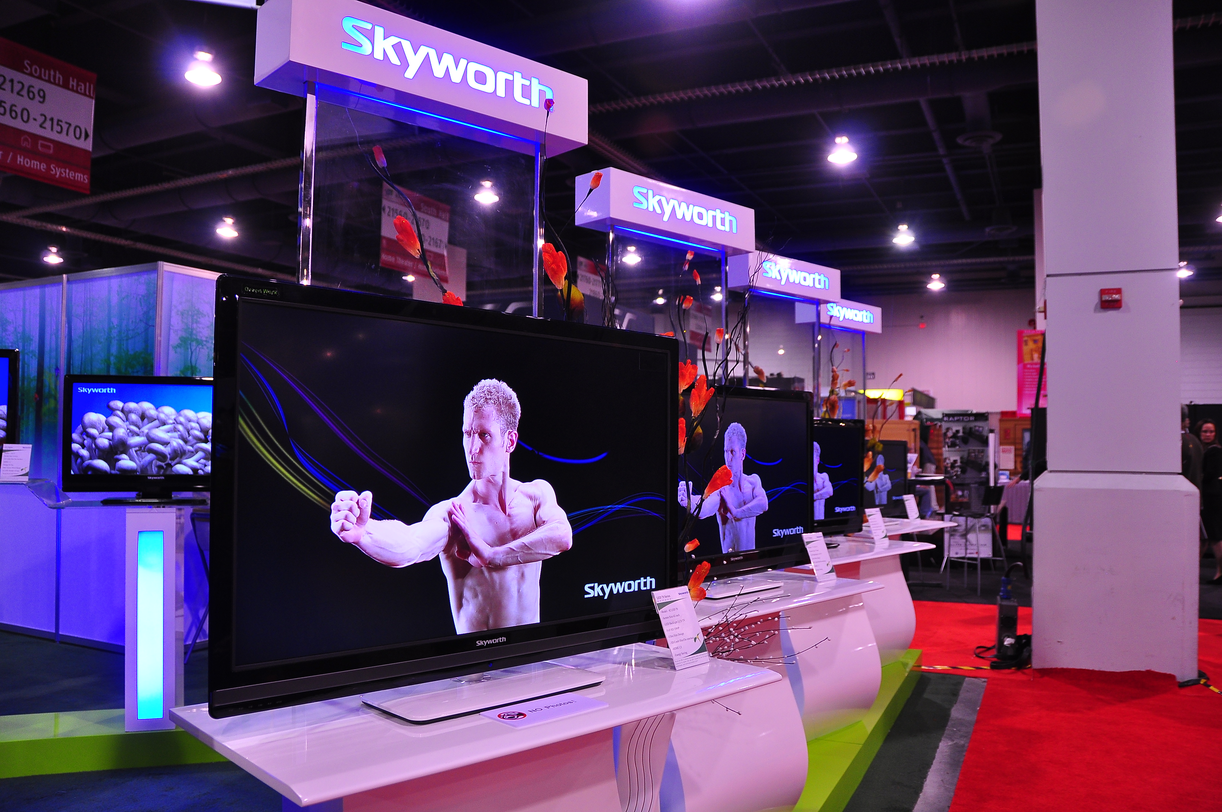 A row of Skyworth flat-panel televisions on display at a trade show