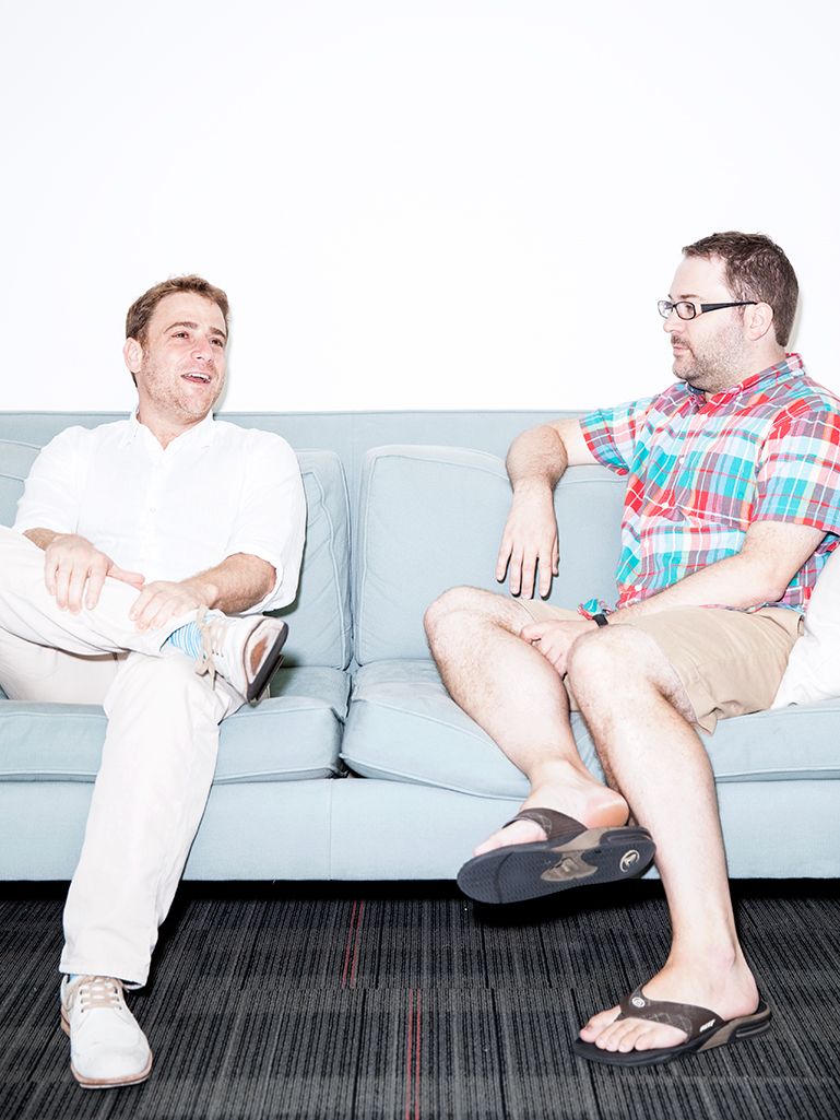 Slack co-founder Stewart Butterfield speaking with a colleague at an early Slack office