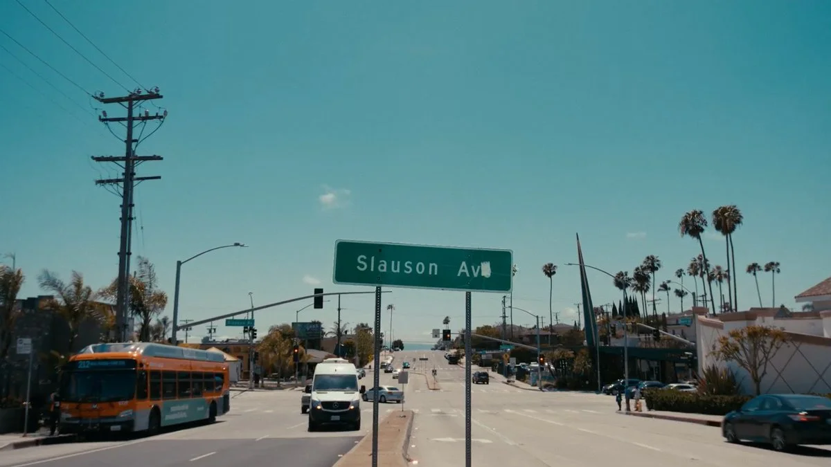Slauson Avenue sign above a palm-lined Los Angeles intersection